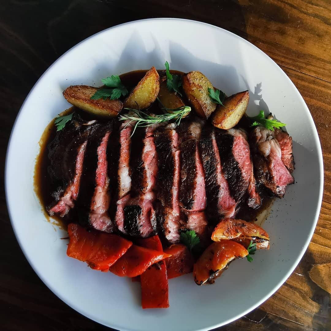 Sliced steak with roasted potatoes